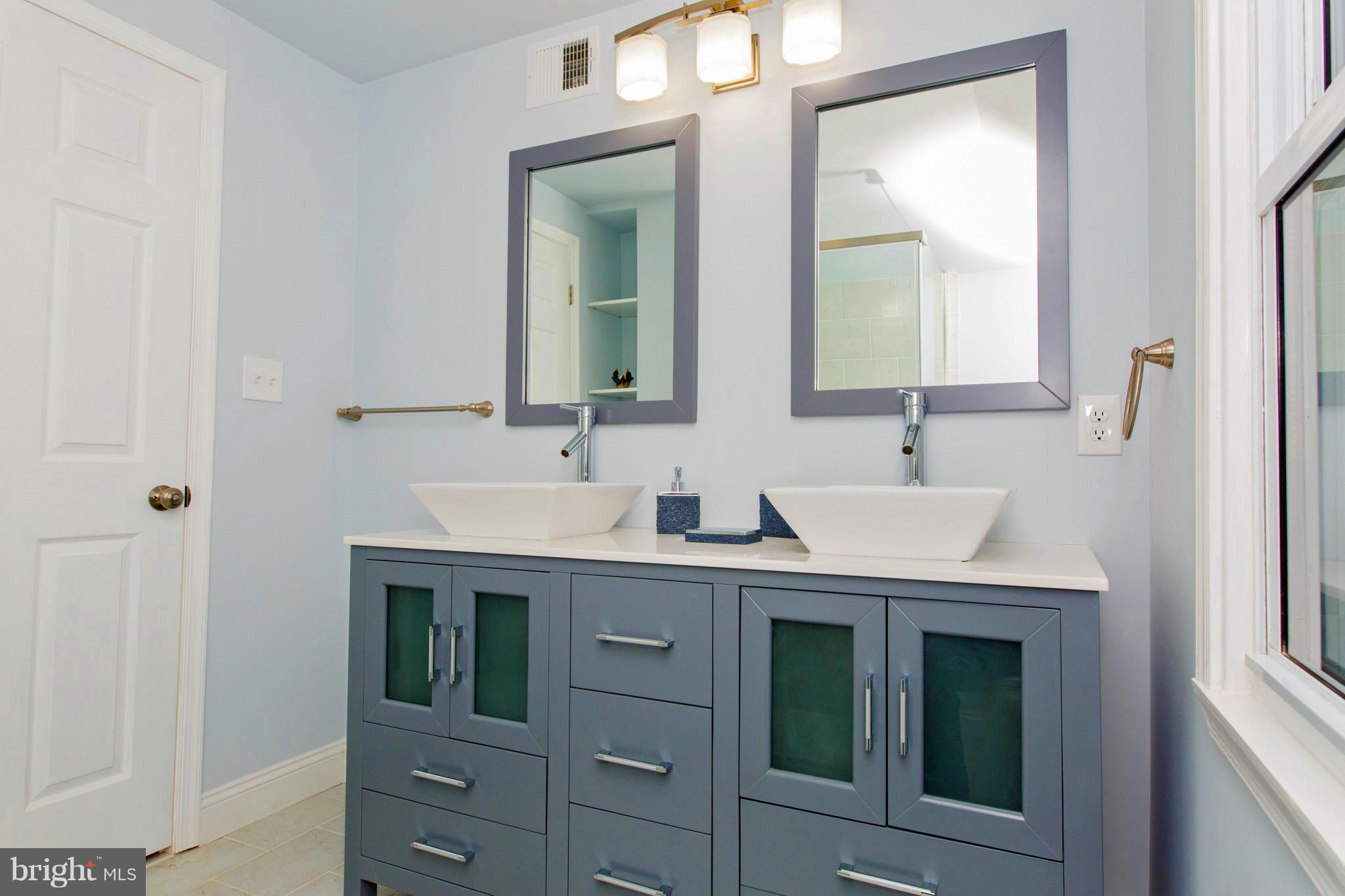 630 Warwick Road Baltimore, MD 21229 - Photo 15 of 23 a bathroom with a sink and a mirror