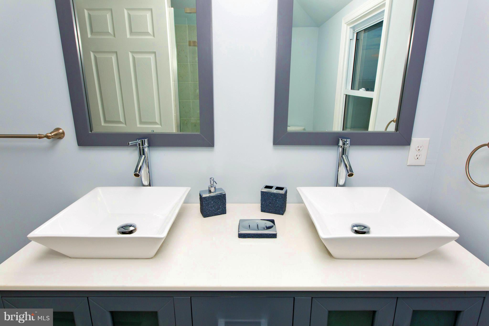 630 Warwick Road Baltimore, MD 21229 - Photo 16 of 23 a bathroom with a sink and a mirror