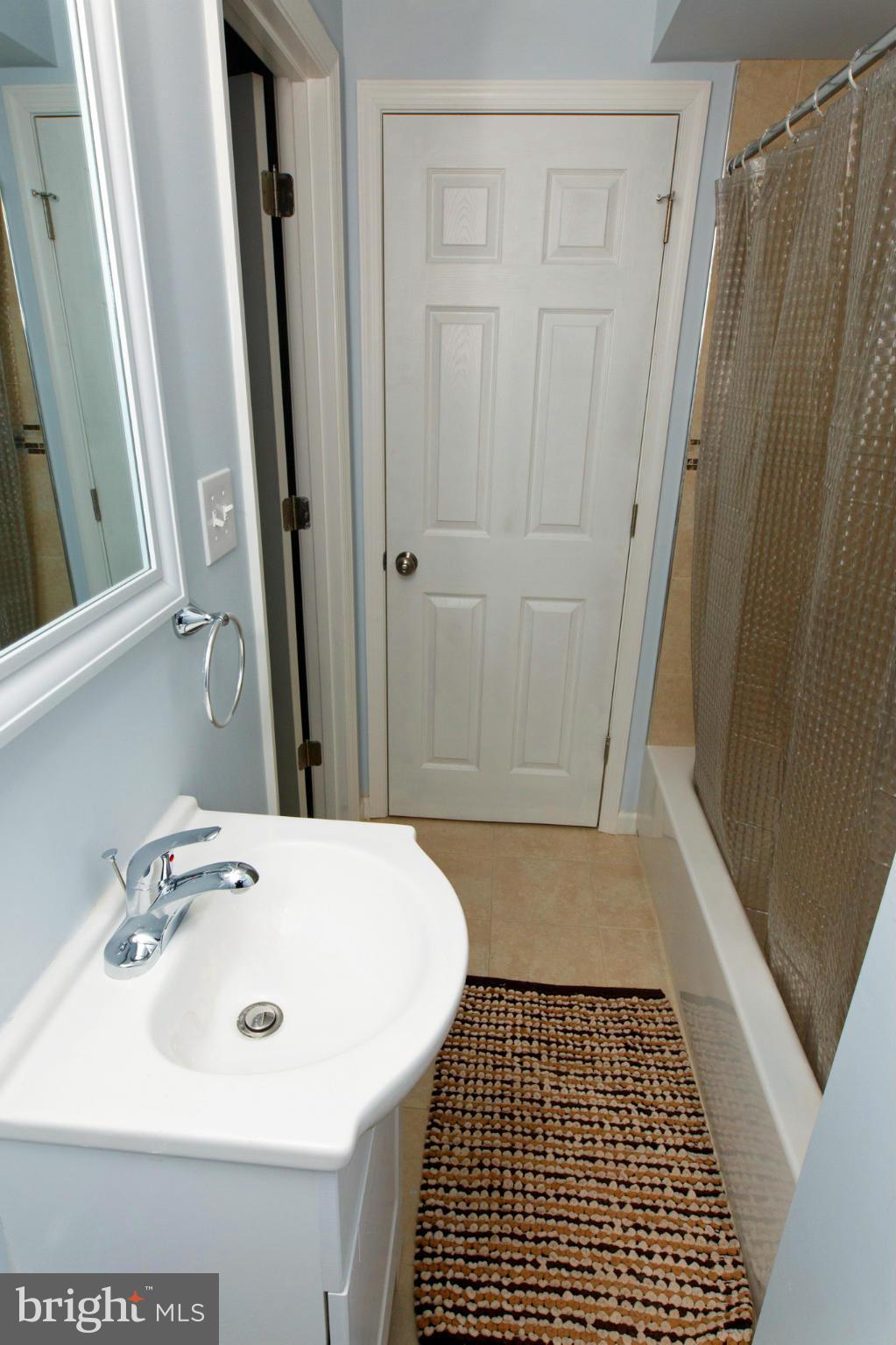 630 Warwick Road Baltimore, MD 21229 - Photo 20 of 23 a bathroom with a sink a mirror and shower
