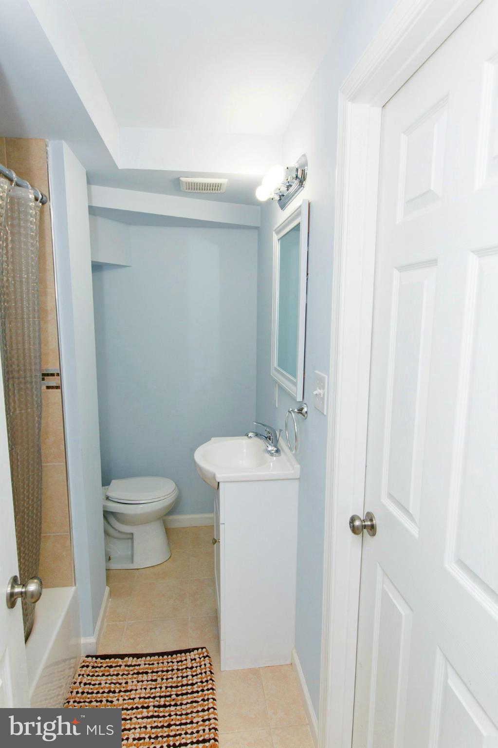 630 Warwick Road Baltimore, MD 21229 - Photo 21 of 23 a bathroom with a toilet a sink and shower