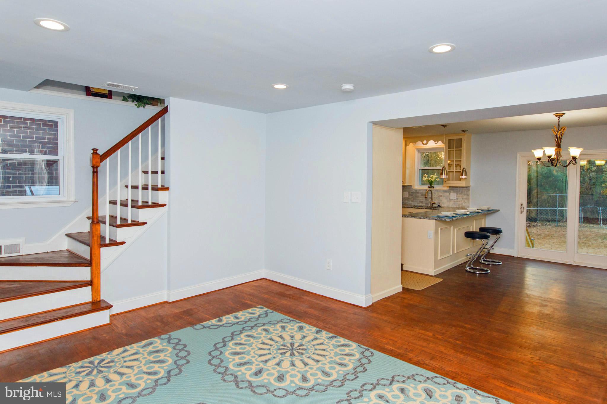 630 Warwick Road Baltimore, MD 21229 - Photo 5 of 23 a view of a hallway with wooden floor and staircase
