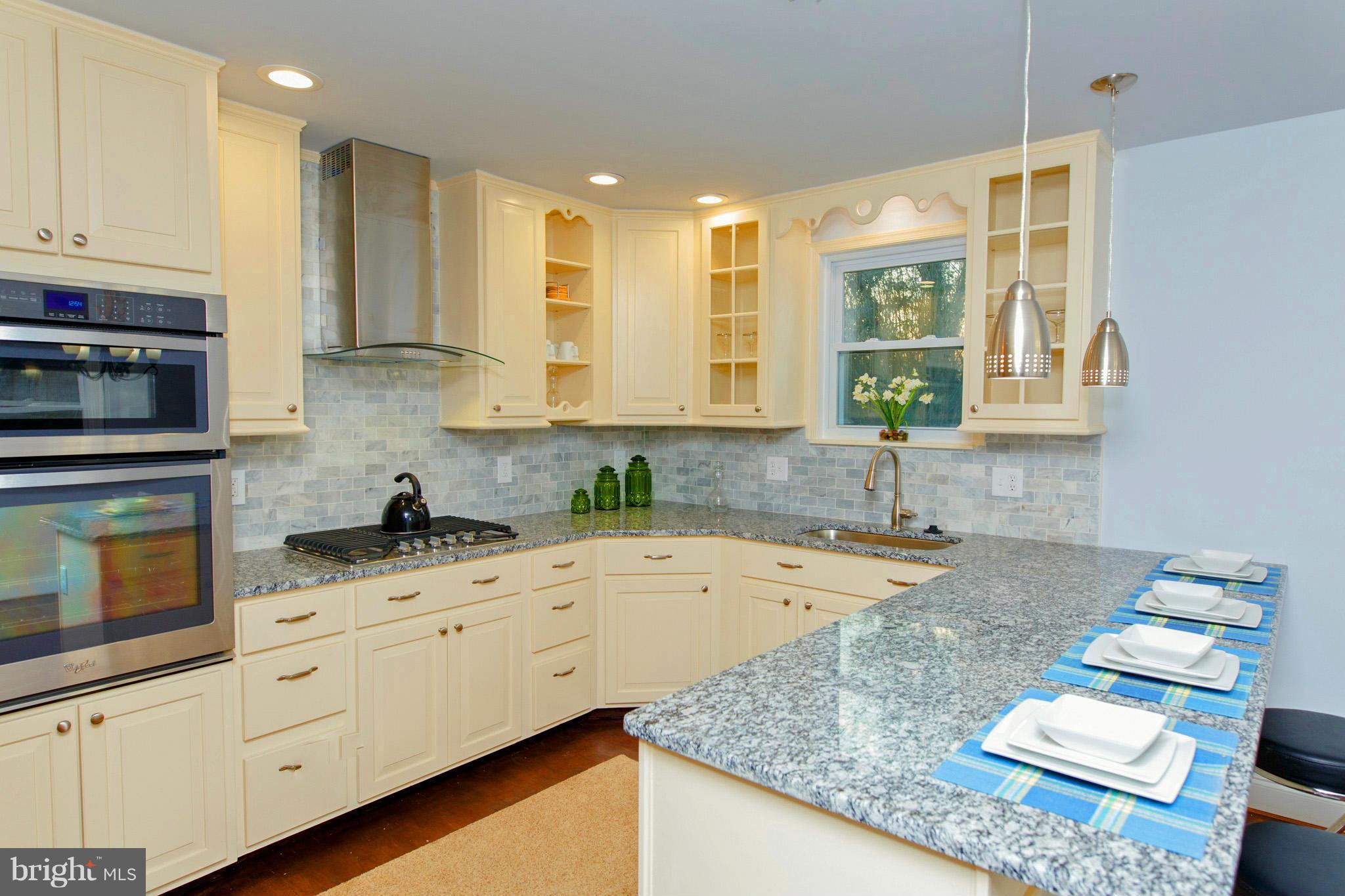 630 Warwick Road Baltimore, MD 21229 - Photo 7 of 23 a kitchen with granite countertop a stove sink and cabinets