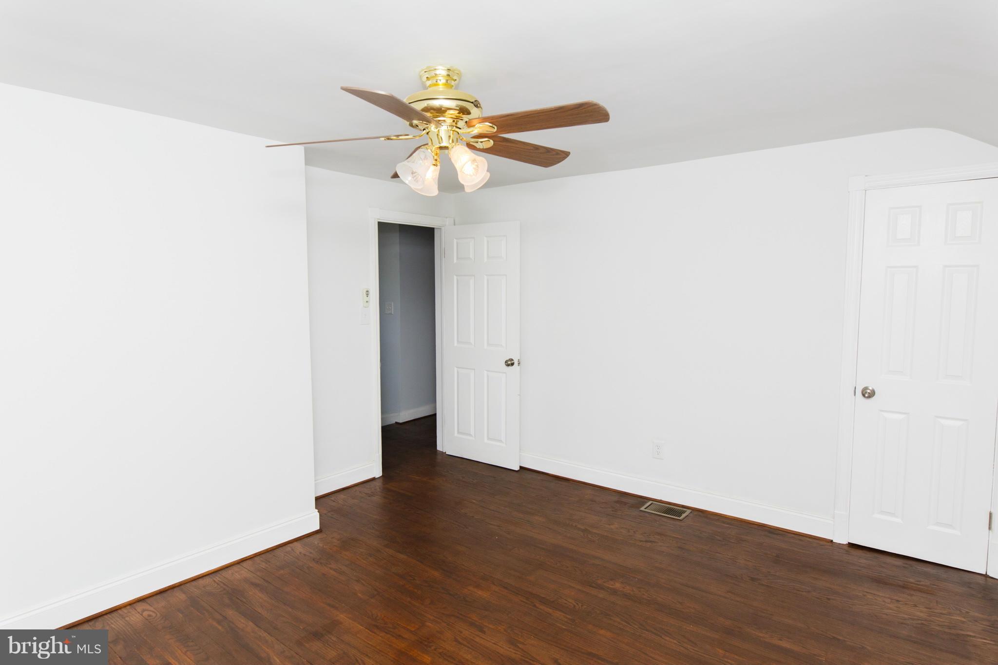 630 Warwick Road Baltimore, MD 21229 - Photo 10 of 23 a view of an empty room with wooden floor