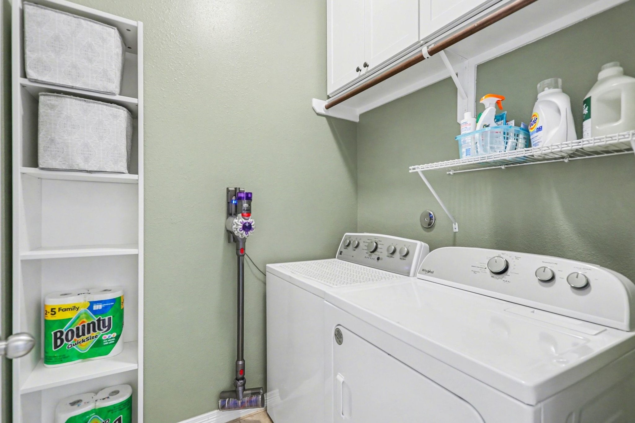 27006 Cliff Pointe Lane Katy, TX 77494 - Photo 30 of 34 Dedicated laundry room with shelving and hanging space, making everyday routines efficient and organized.