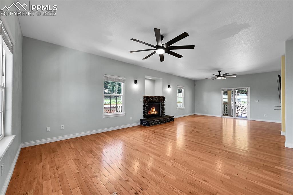 16540 Mesquite Road Peyton, CO 80831 - Photo 13 of 50 a view of empty room with wooden floor and window