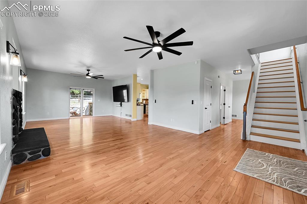 16540 Mesquite Road Peyton, CO 80831 - Photo 14 of 50 a view of a livingroom with hardwood floor and a ceiling fan