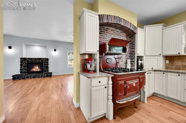 a kitchen with stainless steel appliances granite countertop a stove a sink dishwasher and a refrigerator