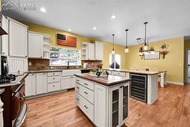 a kitchen with kitchen island granite countertop stainless steel appliances and wooden cabinets