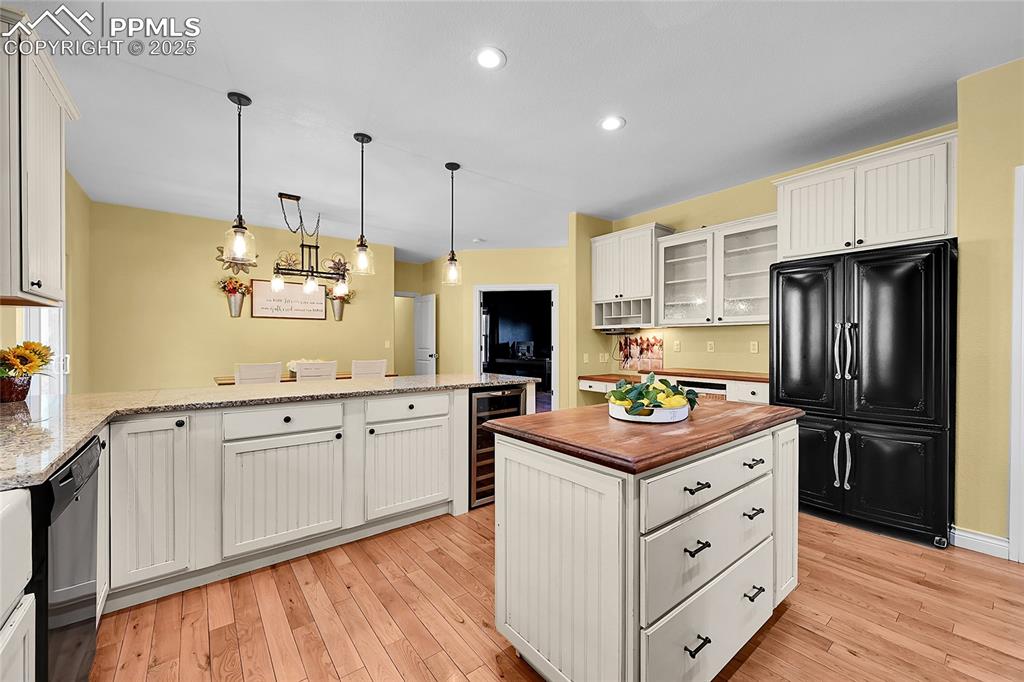 16540 Mesquite Road Peyton, CO 80831 - Photo 19 of 50 a kitchen with kitchen island granite countertop stainless steel appliances and wooden cabinets