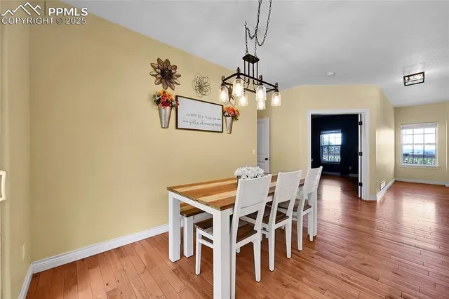 a kitchen with kitchen island white cabinets and refrigerator