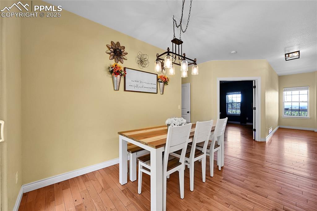 16540 Mesquite Road Peyton, CO 80831 - Photo 21 of 50 a view of a dining room with furniture and wooden floor