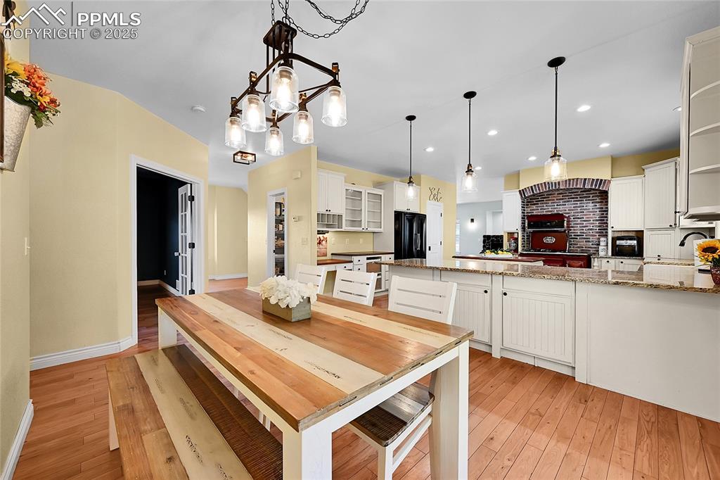 16540 Mesquite Road Peyton, CO 80831 - Photo 22 of 50 a kitchen with kitchen island white cabinets and refrigerator
