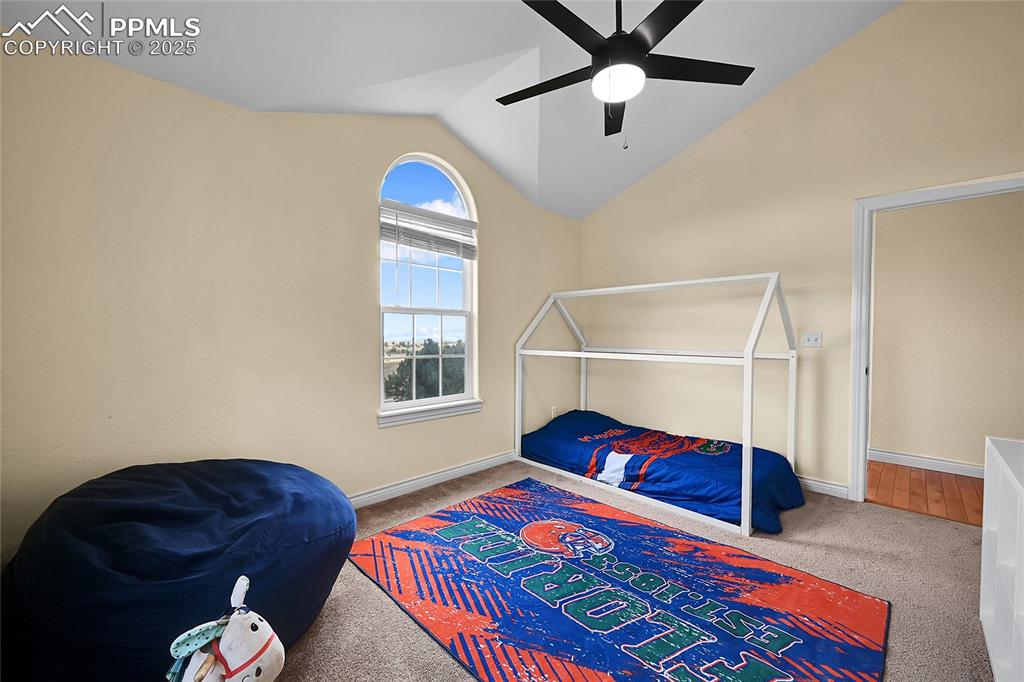 16540 Mesquite Road Peyton, CO 80831 - Photo 31 of 50 a bedroom with a bed and a chandelier