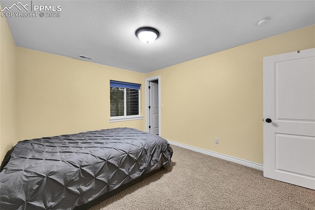 16540 Mesquite Road Peyton, CO 80831 - Photo 37 of 50 a bedroom with a bed and a window