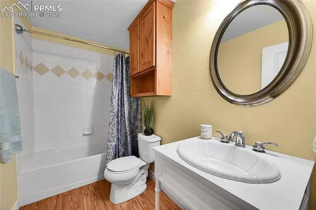 a bathroom with a granite countertop sink a mirror a vanity and a shower