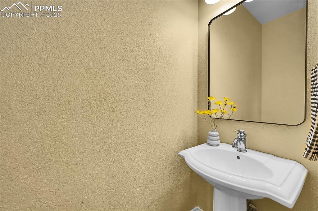 16540 Mesquite Road Peyton, CO 80831 - Photo 40 of 50 a bathroom with a sink and a mirror