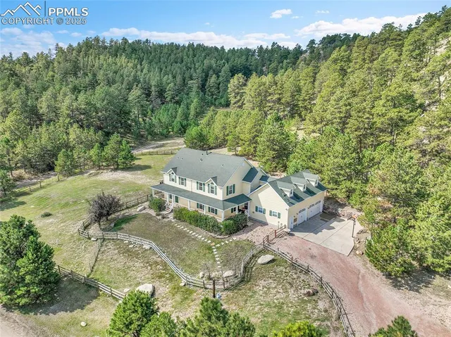 an aerial view of a house with a yard