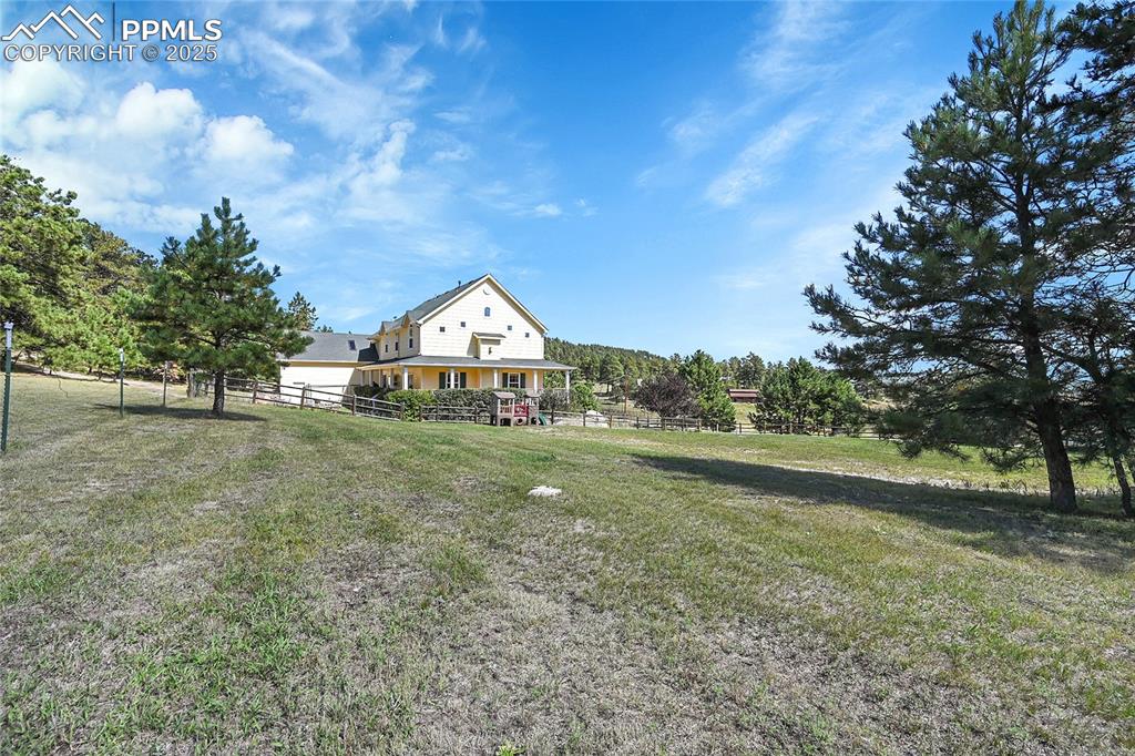 16540 Mesquite Road Peyton, CO 80831 - Photo 8 of 50 a view of a house with a yard