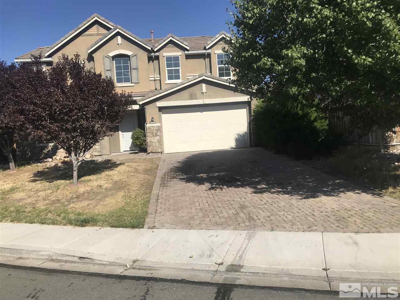 11330 Crotone Way Reno, NV 89521 - Photo 7 of 17 a front view of a house with a yard