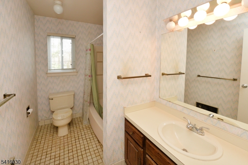50 Rock Road, Unit 7A Hawthorne, NJ 07506 - Photo 12 of 17 a bathroom with a sink a toilet and a mirror
