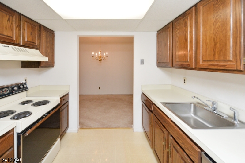 50 Rock Road, Unit 7A Hawthorne, NJ 07506 - Photo 5 of 17 a kitchen with a sink stove top oven and cabinets