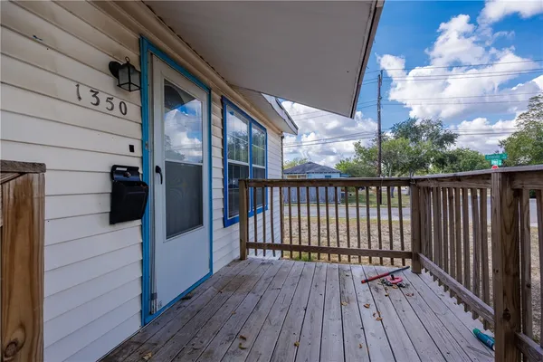 a view of balcony with wooden floor