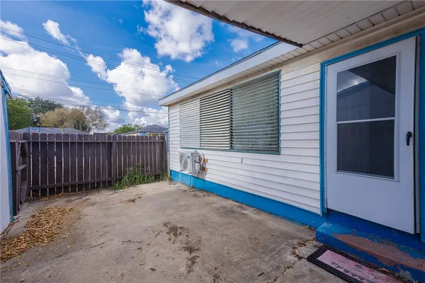 a view of a backyard with wooden fence