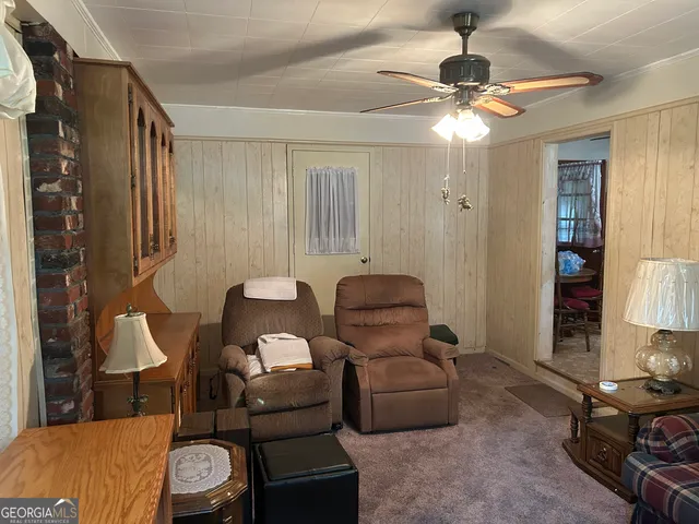 a living room with furniture a lamp and a window