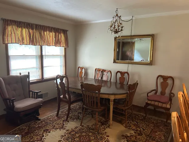 a dining room with furniture and window
