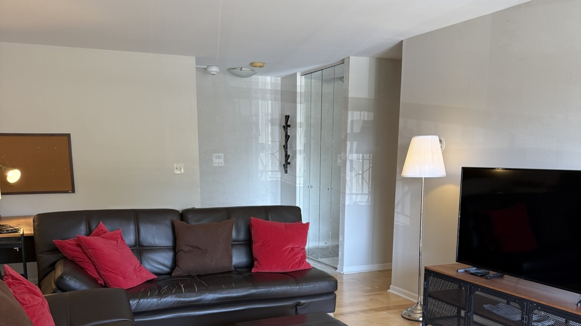 450 Raintree Court, Unit 2B Glen Ellyn, IL 60137 - Photo 2 of 10 a living room with furniture and a flat screen tv