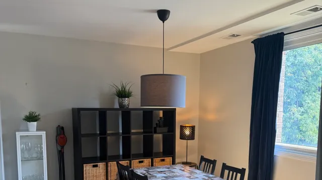 a view of a hallway with wooden floor and stairs