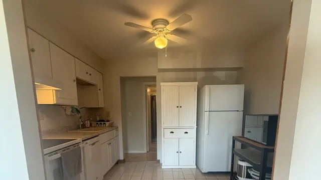 a kitchen with a refrigerator and a sink