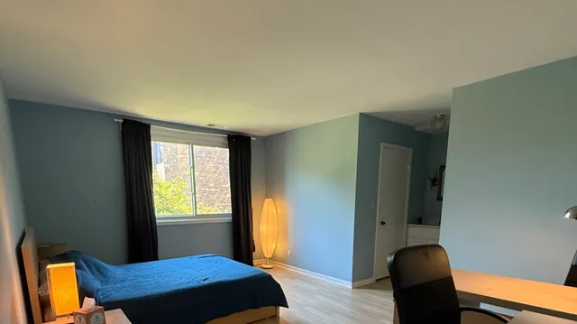 a bedroom with a bed and a window