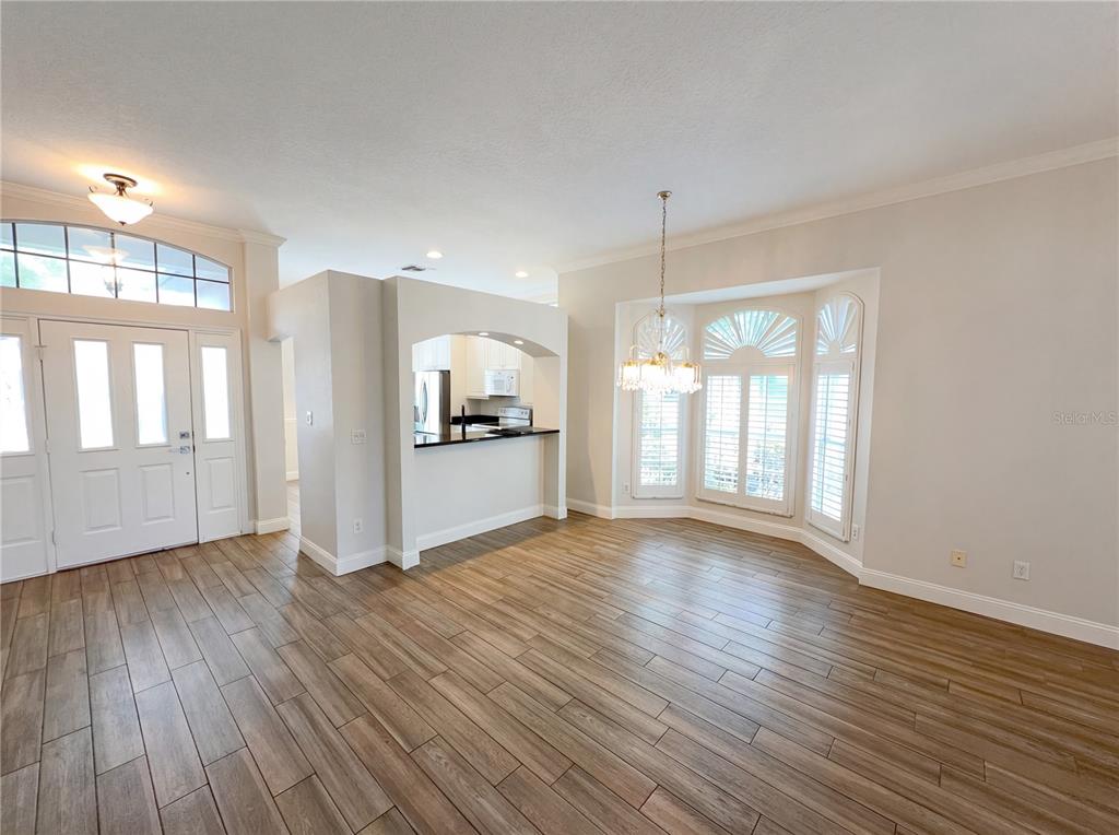 448 MacGregor Road Winter Springs, FL 32708 - Photo 12 of 26 a view of an empty room with a window and wooden floor
