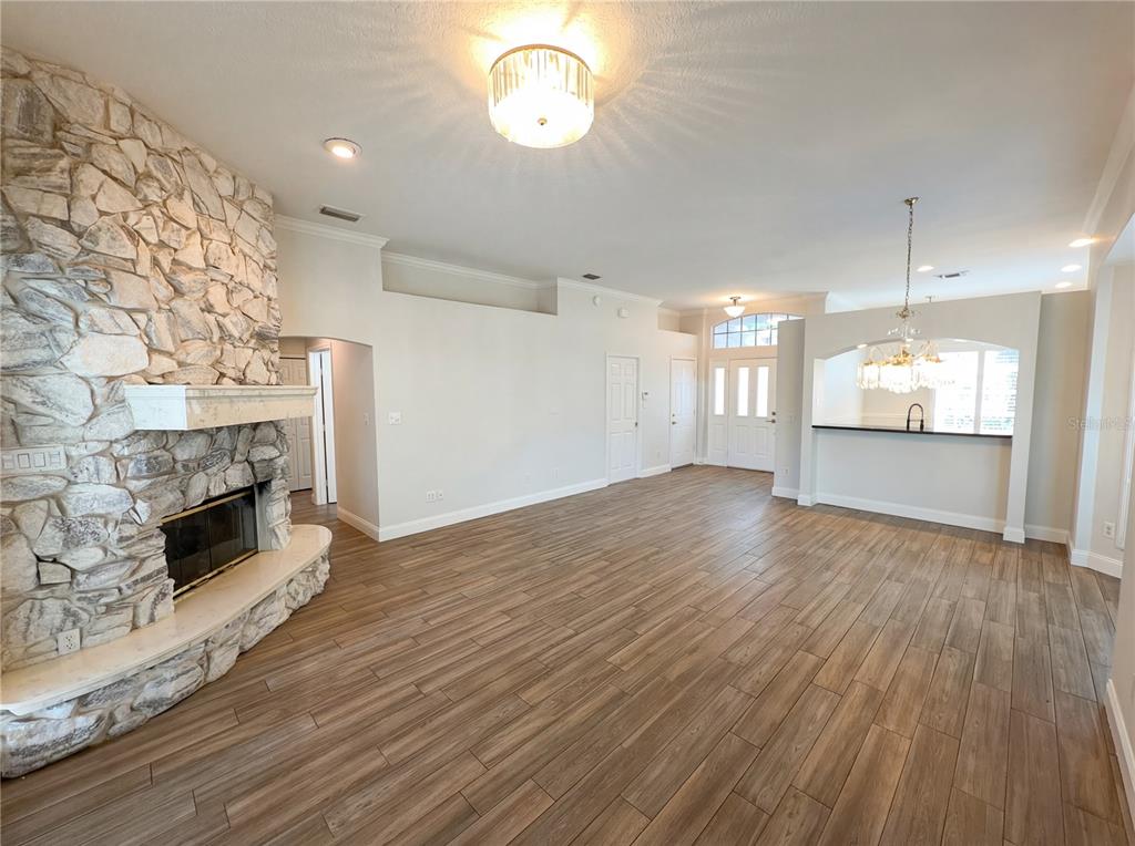 448 MacGregor Road Winter Springs, FL 32708 - Photo 13 of 26 an empty room with wooden floor fireplace and windows