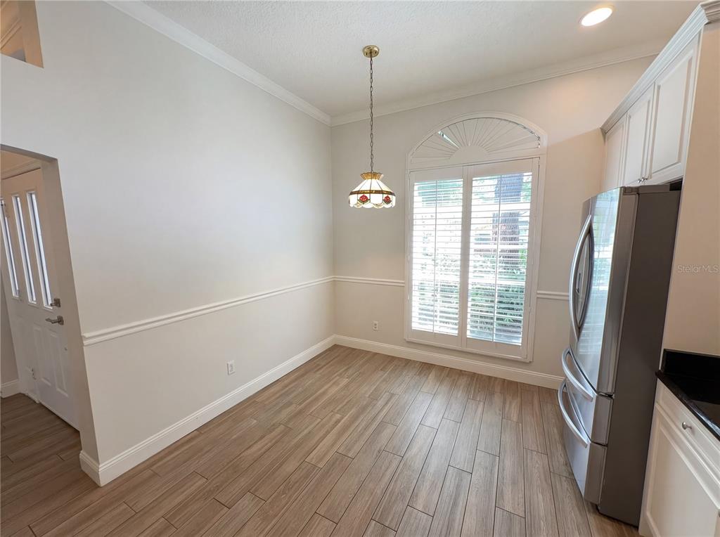 448 MacGregor Road Winter Springs, FL 32708 - Photo 14 of 26 a view of an empty room with a window and wooden floor