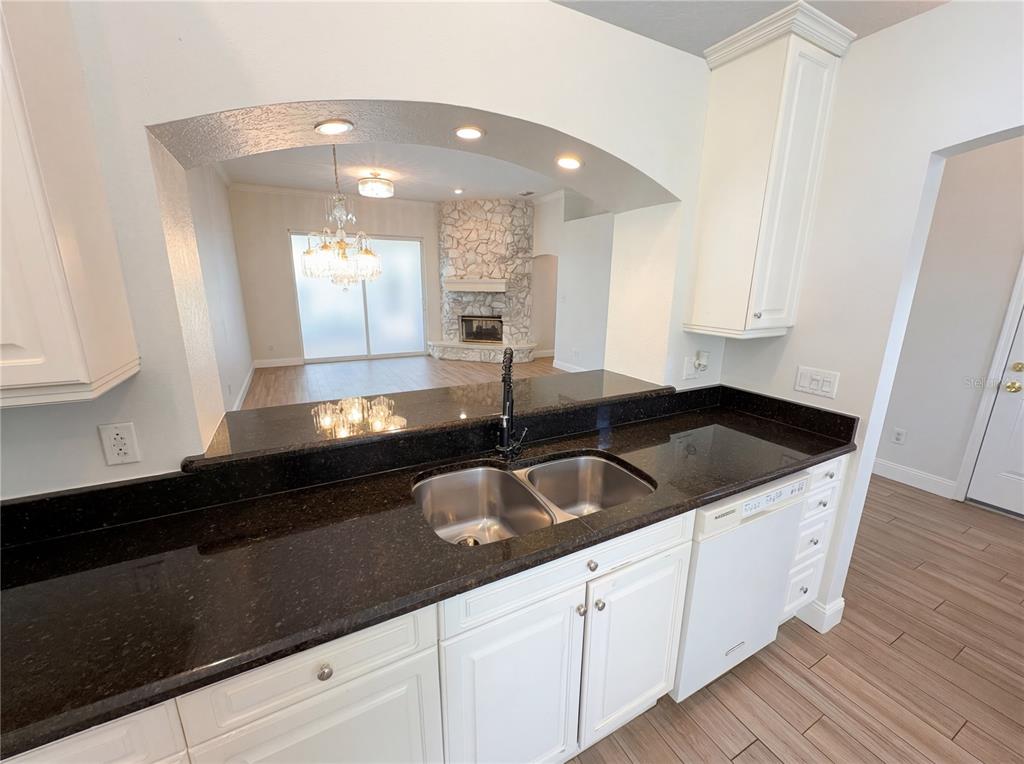 448 MacGregor Road Winter Springs, FL 32708 - Photo 16 of 26 a kitchen with granite countertop a sink and a white cabinets