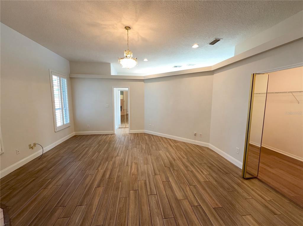 448 MacGregor Road Winter Springs, FL 32708 - Photo 4 of 26 an empty room with wooden floor and window