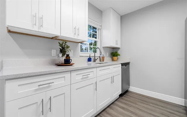 a kitchen with white cabinets and a sink