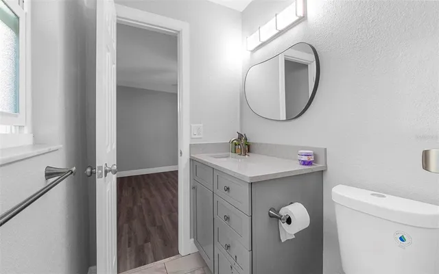 a bathroom with a sink a toilet and a mirror