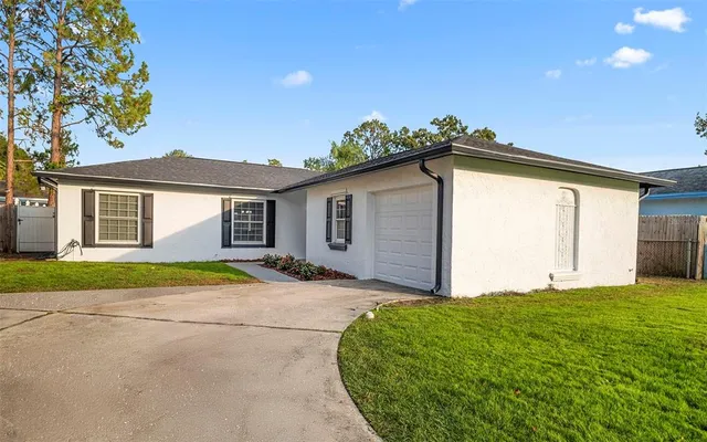a yellow house with trees in front of it