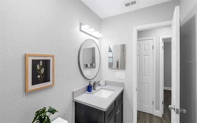 a bathroom with a sink and a mirror