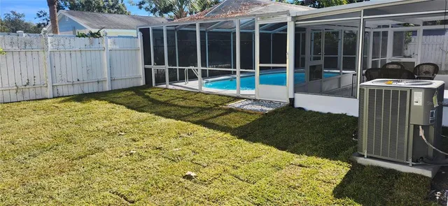 a view of a backyard with wooden floor and fence