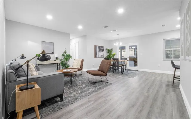 a living room with furniture and wooden floor