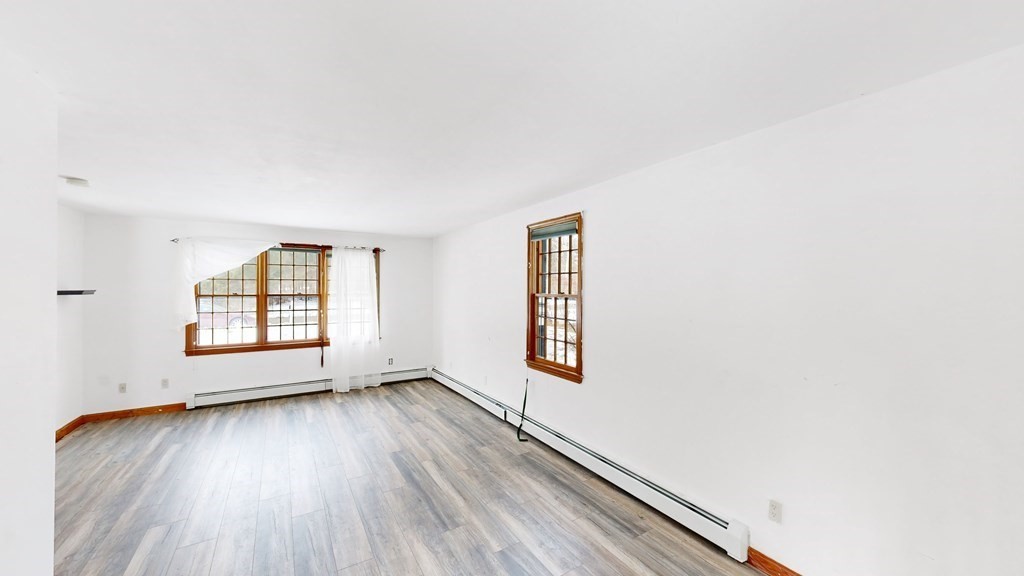 5 Scott Hill Road Ipswich, MA 01938 - Photo 11 of 25 an empty room with wooden floor and windows