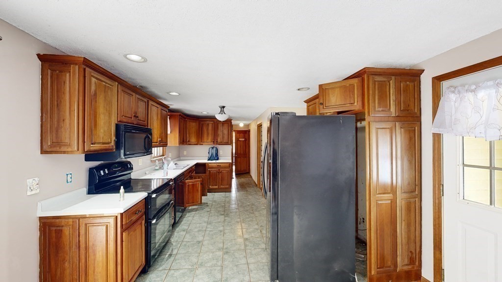 5 Scott Hill Road Ipswich, MA 01938 - Photo 3 of 25 a kitchen with stainless steel appliances a refrigerator and a stove top oven