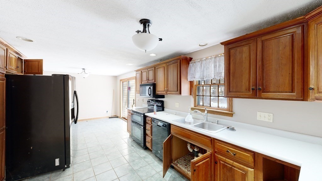 5 Scott Hill Road Ipswich, MA 01938 - Photo 4 of 25 a kitchen with stainless steel appliances granite countertop a refrigerator and a sink