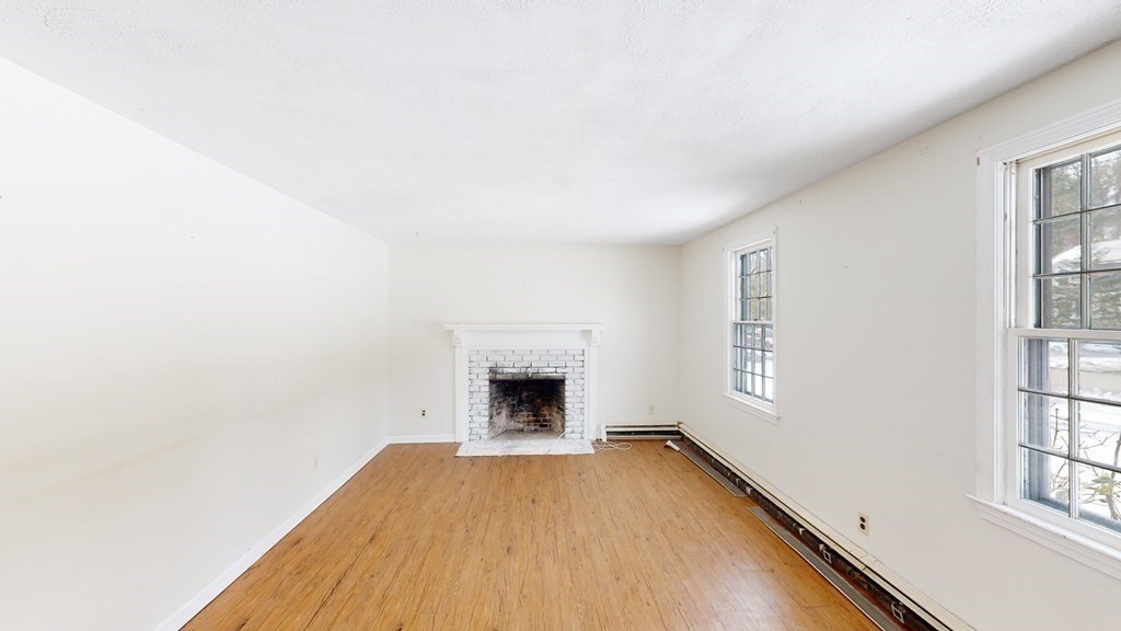5 Scott Hill Road Ipswich, MA 01938 - Photo 9 of 25 an empty room with windows and fireplace