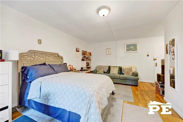 a bedroom with double bed and a couch