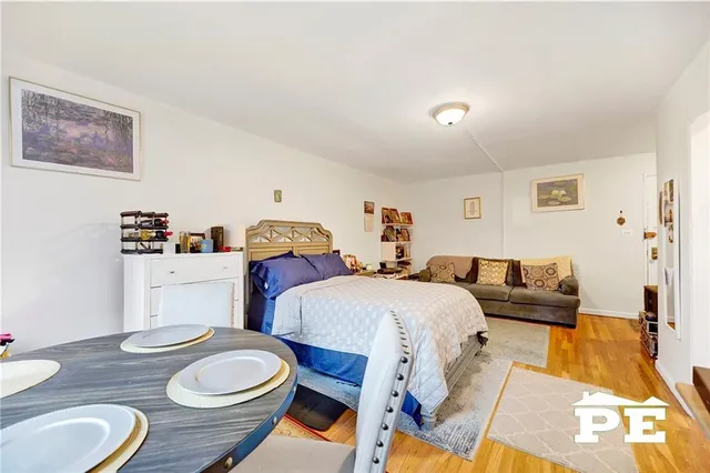 a bed room with two beds and wooden floor